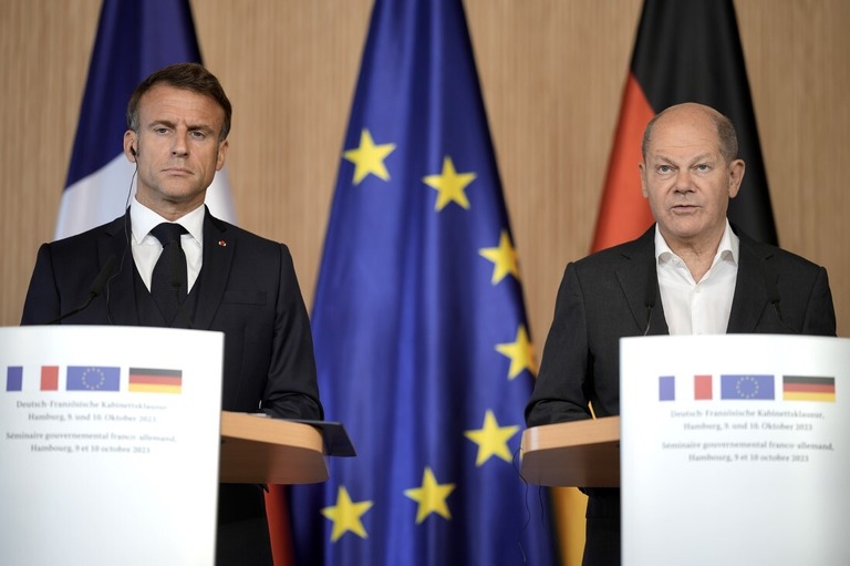 独仏合同閣議後の記者会見で話すフランスのマクロン大統領（左）とドイツのショルツ首相（右）＝１０日、ドイツのハンブルク/Markus Schreiber/AP