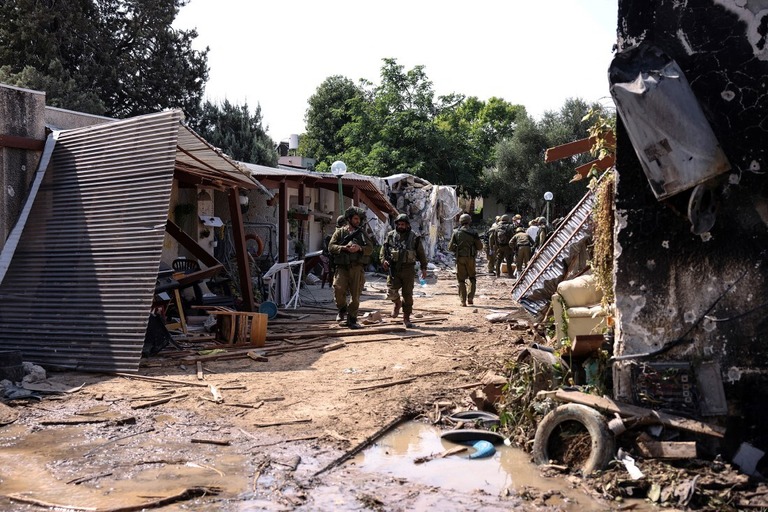 住宅地を歩くイスラエル兵＝１０日、イスラエル南部クファルアザ/Ronen Zvulun/Reuters
