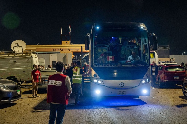 １２日、ガザ地区から避難したカナダ国籍保持者を乗せたバスがラファ検問所を通過する様子/Ali Moustafa/Getty Images