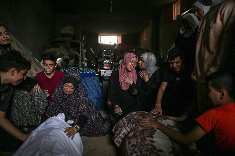 イスラエル軍の攻撃によって死亡したパレスチナ人の遺族ら＝１３日、パレスチナ自治区ガザ地区ハンユニス/Mustafa Hassona/Anadolu/Getty Images
