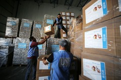 避難所に逃げてきたパレスチナの人々に支援物資を届ける準備をする国連の職員＝１１月４日