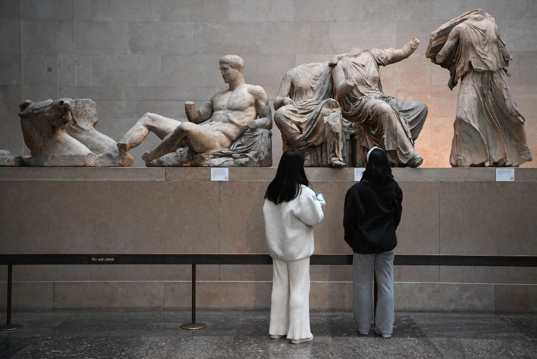 ロンドンの大英博物館でギリシャ・パルテノン神殿の彫刻群「エルギン・マーブル」を見る来館者/Daniel Leal/AFP/Getty Images/File