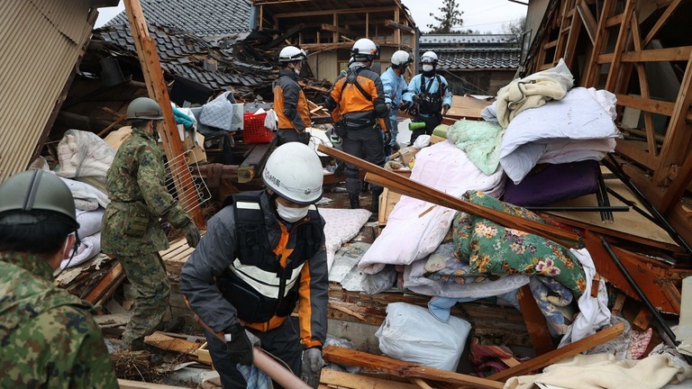 石川県珠洲市で倒壊した建物から高齢男性の救助を行う救急隊と自衛隊＝３日/The Asahi Shimbun/Getty Images