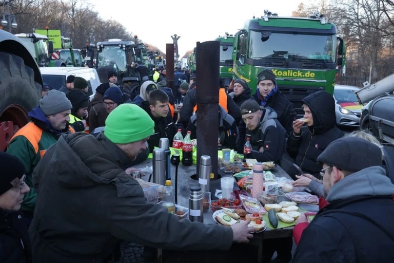 車両の近くで集まって朝食を取るデモ参加者ら/Sean Gallup/Getty Images