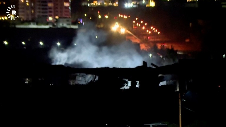 攻撃を受けて煙を上げる建物＝イラク・アルビル/Rudaw TV/AP