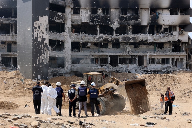 ガザ市のシファ病院での遺体回収作業を見守る国連チーム/AFP/Getty Images