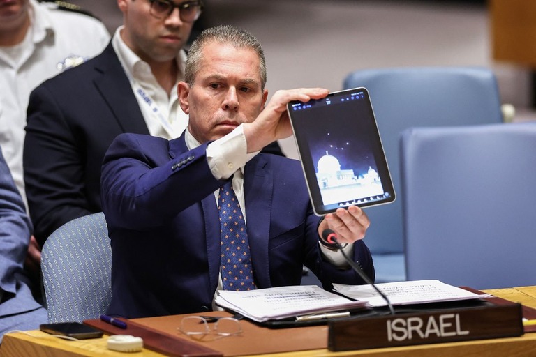 イスラエルへ向かってくるドローンやミサイルの映像を見せるイスラエルのエルダン国連大使＝１４日/Charly Triballeau/AFP/Getty Images