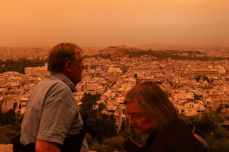 サハラ砂漠からの砂で大気がオレンジ色となったギリシャの首都アテネ＝２３日/Costas Baltas/Anadolu Agency/Getty Images