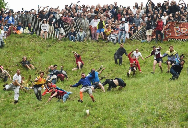 英国のクーパーズヒルで開催された「世界一危険」なレースに参加した人々/Joe Giddens/PA/AP