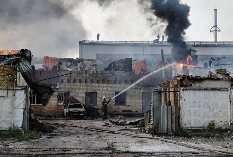 ロシアの攻撃を受け、消火活動にあたる消防士＝１０日、キーウ/Thomas Peter/Reuters
